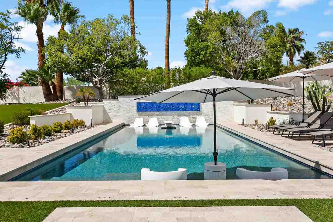 Luxurious backyard pool with lounge chairs