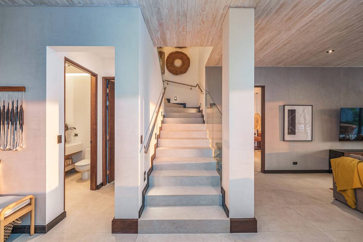 Modern interior with a staircase centered between a bathroom and living area