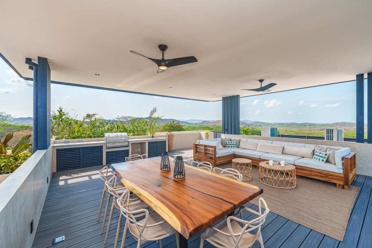 Covered outdoor patio with a wooden dining table